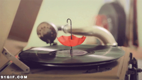 古老唱片上旋转的小红伞图片:唱片,留声机