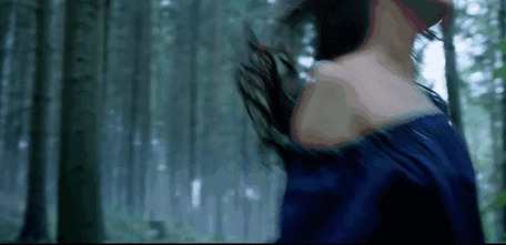 露肩的女人走在树林里露出自己的肩膀gif图片