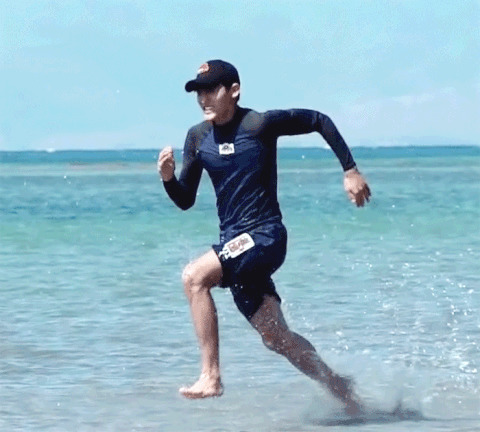 一位体育爱好者穿着运动装在大海边跑步gif图片
