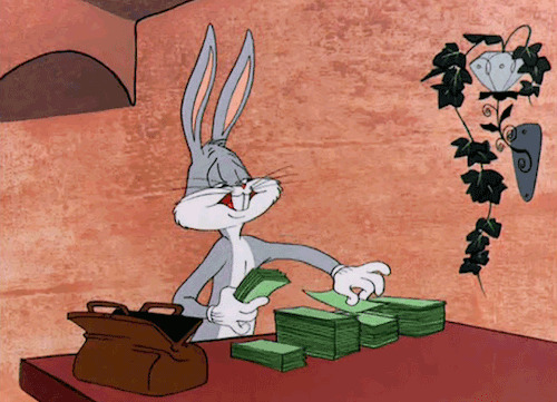 兔八哥坐在桌子前数钞票GIF图片